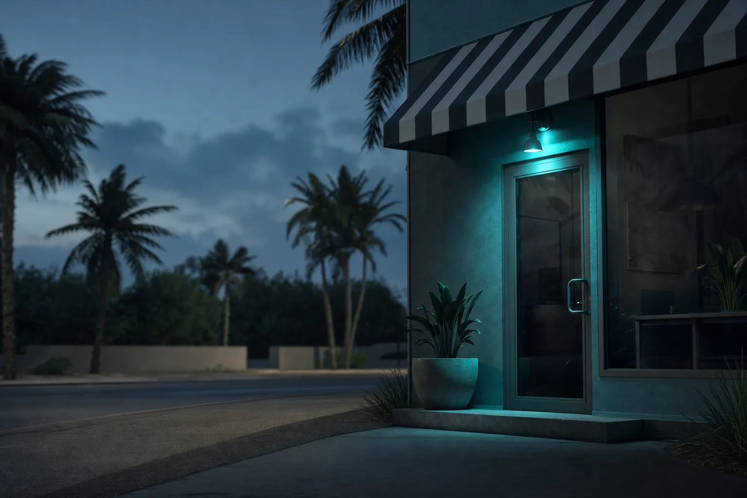 A small storefront with an awning on a quiet Florida street at blue hour.