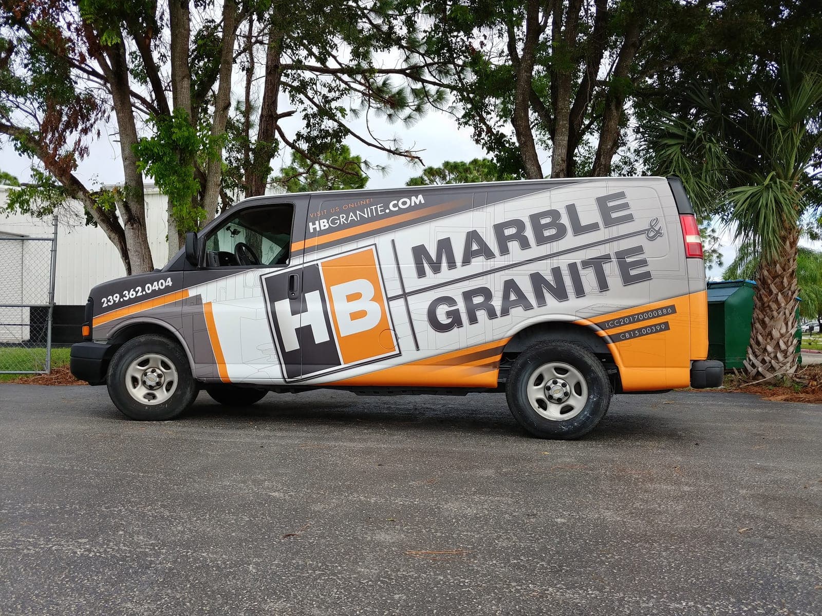 Grey and orange service van wrap for HB Marble and Granite with a large HB logo block, side view.